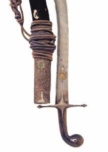 268 269 268 A TURKISH KILIG, LATE 18TH/19TH CENTURY with reinforced watered blade of characteristic form, decorated on each side with a small panel of gold koftgari scrollwork towards the tip and a