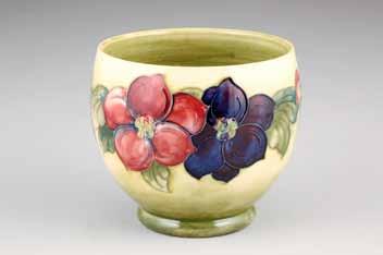 5cm high 100-150 (+ 21% BP*) 298 Moorcroft pottery plant pot, pale green ground decorated with Hibiscus, original label to