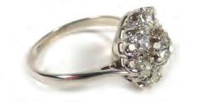 Lot 534 534 A platinum cluster ring set centrally with a brilliant cut diamond in a