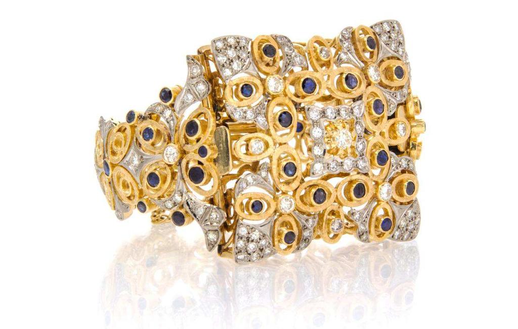Lot 271 An 18 Karat Yellow Gold, Platinum, Diamond and Sapphire Bracelet, Lalaounis, containing numerous round brilliant and single cut diamonds weighing approximately 3.