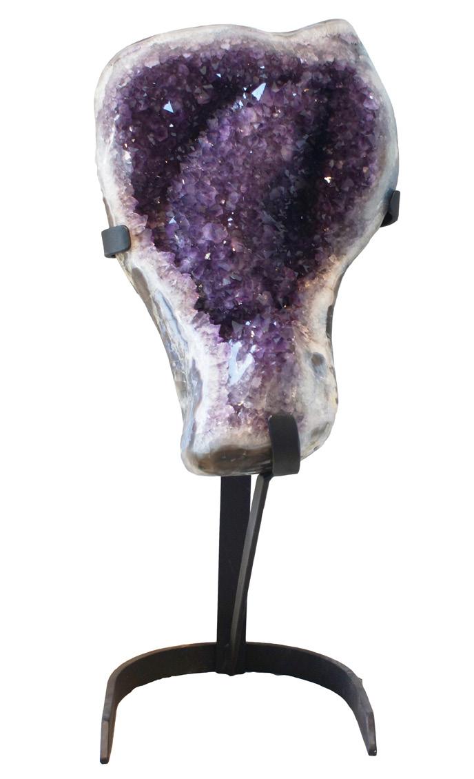 AMETHYST GEODE The piece stands nearly 3 ½ feet tall and is incredibly unique in its undulating formation which what is called a flower in crystal parlance in the middle of the geode with deep