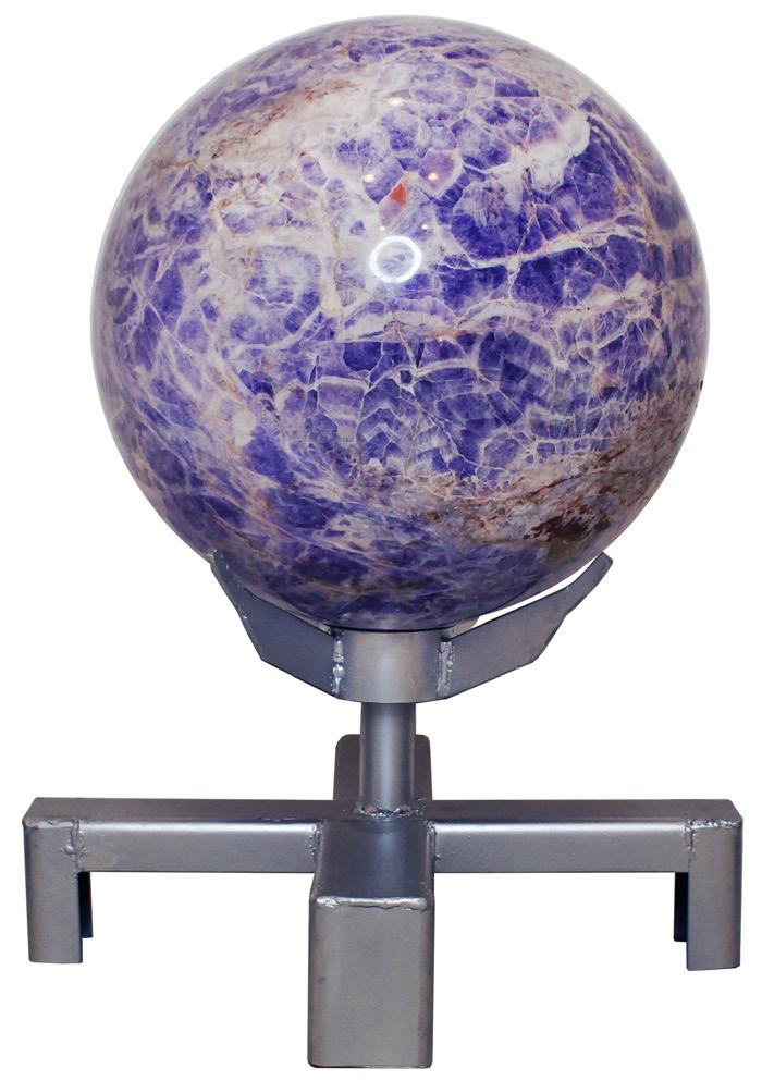 CHEVRON AMETHYST SPHERE This dynamic chevron amethyst sphere, weighing nearly 225 lbs and rising just over 2 feet, sits in a rotating, silver-colored base.