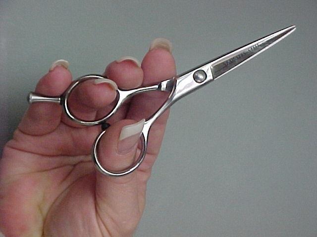 Holding the Shears Place thumb in moving blade (bottom blade) Place ring finger in the top