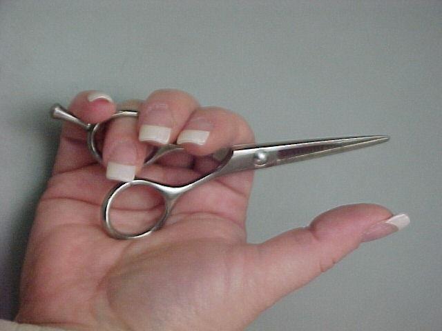 Palming the Shears Close shear points Slide thumb out of ring