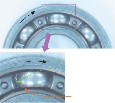 After the bearing was rotated it was found that the grease had migrated to the leading edge, with respect to rotation, of the cage pocket (Fig. 3).