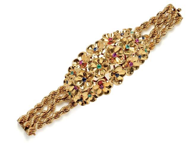434 434 18kt Gold Gem-set Bracelet, Gübelin, c. 1950s, designed as a central bombé section with florets set with circular-cut emeralds, sapphires, and rubies, completed by heavy ropetwist chain, 84.
