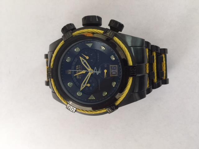 Item 27: Make: Invicta Model: Bolt chronograph Reference: 15780 Serial: 1166531 Case Metal: Gold plated stainless steel Case Diameter: 50mm Dial: Blue Bezel: Fixed (gold plated with blue wire cables)