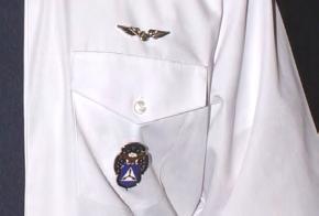 Specialty badges are worn centered below left pocket.