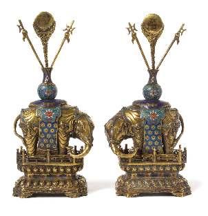 513 512 A Pair of Gilt Bronze and Cloisonné Enamel Models of Elephants each igure depicted standing foursquare on a double lotus waisted base incised with a keyfret band and raised on four ruyi feet,