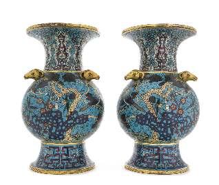 517 518 519 517 A Pair of Cloisonné Enamel Hu Vases each pear shaped body supported on a tall splayed foot rising to a waisted neck and a laring mouth with straight gilt rim, the shoulder set with