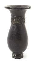 Height 7 inches. $2,000-4,000 532* A Bronze Vase the pear shaped body rising to a lared mouth, the neck cast with scroll decoration. Height 5 1/2 inches. Property from the Dr. Peter M.