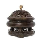 553 A Bronze Covered Incense Burner LATE QING DYNASTY the body of square sectioned with sloping sides, raised on a tall straight square foot, the exterior cast to depict mythical beasts and sinuous