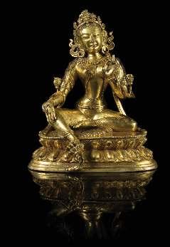 584 A Sino-Tibetan Gilt Bronze Figure of Tara the deity shown seated in lalitasana on a shaped lotus base, her hands raised in vitarkamudra and varadamudra, wearing a