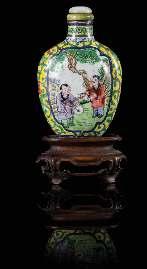 Property of a Private Midwest Collector $800-1,200 731 731 A Cloisonné Enamel Snuf Bottle of lattened form with a recessed waist, decorated overall with lower heads and leafy branches against a blue