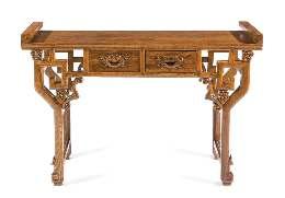 776 777 778 776 A Massive Hardwood Altar Table, Qiaotou an the rectangular top lanked by a pair of everted terminals, above a recessed waist and shaped aprons inely carved with lingzhi sprays, raised