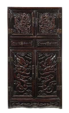 788 A Carved Hardwood Cabinet of rectangular form, the top drawers having a pair of pull out doors carved with two winged phoenix, above two doors decorated with dragons amidst clusters of clouds