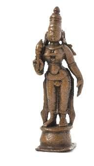 827* An Indian Copper Figure of Lakshmi 18TH/19TH CENTURY the igure depicted standing holding a lotus bud. Height 4 1/4 inches. Property from the Collection of John J.