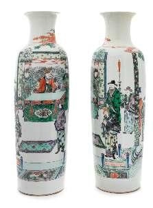 187* A Pair of Famille Verte Porcelain Vases 19TH CENTURY each having a slender baluster form body painted with igures in an interior scene. Height 23 1/2 inches. Property from the Dr. Peter M.