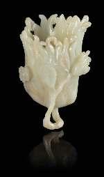 Roth, Aspen, Colorado $1,000-2,000 295* A Small Celadon Jade Carving depicting a lotus bud beginning to blossom, the light celadon stone with russet and white inclusions, raised on a itted wood base.