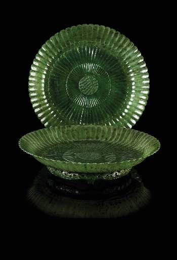 310 310 A Pair of Mughal Style Carved Spinach Jade Chrysanthemum Plates 19TH CENTURY each of a mottled green stone with darker inclusions, the circular form plate having a foliate rim and carved with