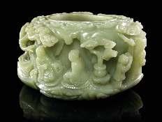 336 Two Carved Jade Ink Rests each of circular form, raised on four paw feet, the top carved with a shou character, together with one double gourd-form coupe, carved with branches and a small gourd.