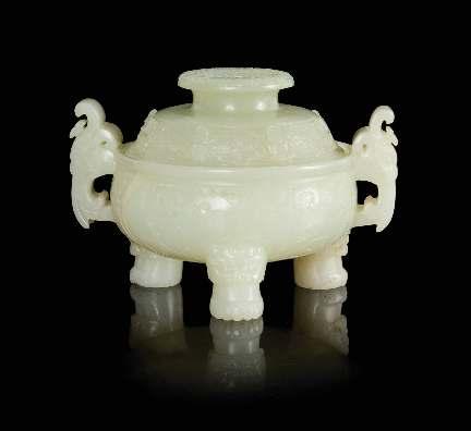 340 340 A Carved Jade Tripod Censer and Cover 19TH CENTURY the compressed spherical body of a mottled near-white stone with some dark brown speckles, raised on three animal feet below beast masks,