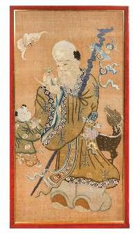423* A Chinese Embroidered Silk Panel 19TH CENTURY the rectangular panel worked in multi-colored threads depicting the immortal of longevity Shoulao standing bearing a staf suspending a ribbon-tied