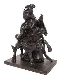 maker s mark. Width 5 1/2 inches. 454 A Carved Wood Figure of Kannon the igure depicted seated on a mythical beast, kirin bearing a scepter in her hands. Height 14 1/2 inches.