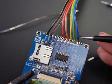 Solder a ribbon cable to your display (OLED shown) as directed on the wiring page, however