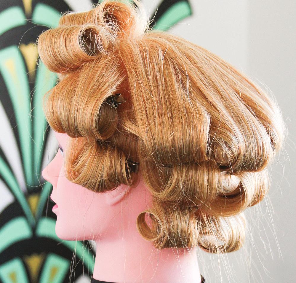These pieces should also roll a little low, so that the hair at the back of the crown stays straight, not curly.