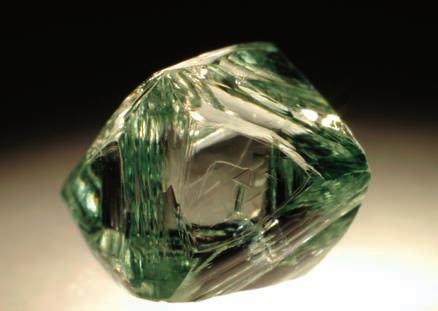 3-28: Strongly resorbed, octahedral diamond with homogeneous pale green surface color (0.93 ct).