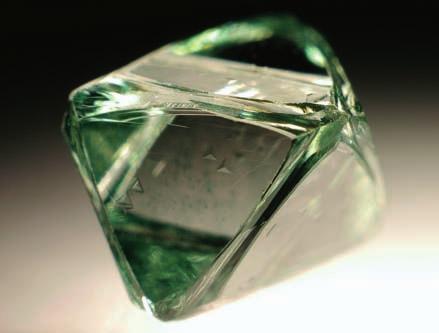 3-31: Octahedral diamond with a transparent green surface that is formed by numerous faint green surface spots (0.76 ct).