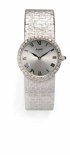 329 330 331 329 Lady s 18kt White Gold and Diamond Wristwatch, Piaget, the oval dial with Roman numeral indicators, diamond bezel, and manual-wind movement, 22 mm, no.