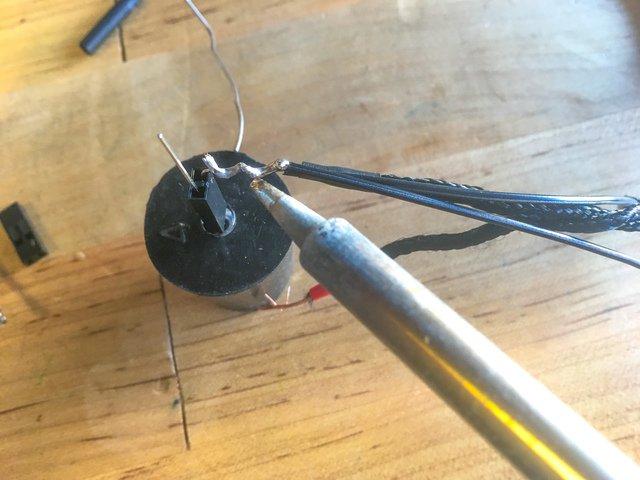 Place a length of heat shrink tubing over the positive wire before soldering to the anode (longer) leg of the LED.