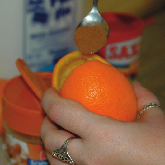 With a teaspoon, scoop out all of the fleshy insides of your orange, and throw them away.