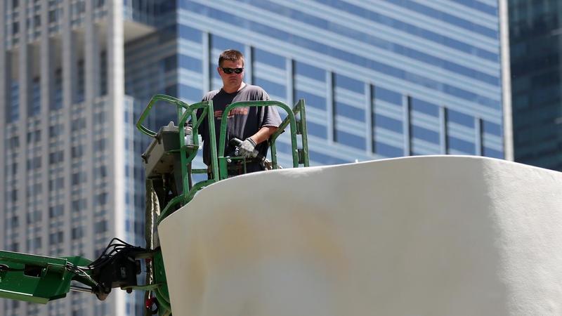 Ironworker Mike Grencik works with a crew to erect a 39-foot high sculpture "Looking Into My Dreams, Awilda" by Jaume Plensa, the renowned artist who also designed Millennium Park's Crown Fountain.