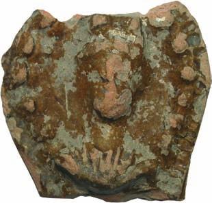 Fig. 4. Handle of ceramic patera, Sirmium, (south rampart area) Сл. 4. Дршка керамичке патере, Сирмијум (ареал јужног бедема) On the top of the head are two protuberances, most probably the tips of the moon crescent.