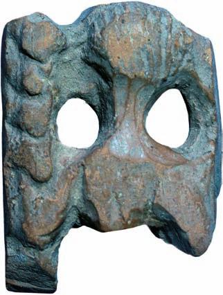 handle (?) made of reddish fired clay, coated with yellowish engobe. The preserved decoration consists of the head and part of the bust of a female, flanked with vertical column-like borders.