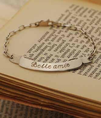 802 > belle amie / beautiful friend bracelet 34 french engraved Beautiful sentimental French phrases of love have been hand engraved onto sterling silver ribbon motifs that swing elegantly from fine