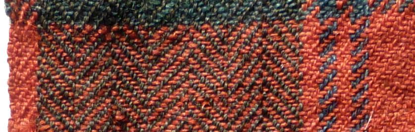 The missing selvedge would therefore be the narrow red between the fine blue lines which gives a balanced pattern in which one repeat plus the selvedge pattern would have spanned the whole width of