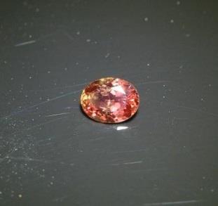 Sapphire Sri Lanka. Oval brilliant. One half carat +. Padparasha rarer sapphire color is a pinkish orange. Eye clean and bright.
