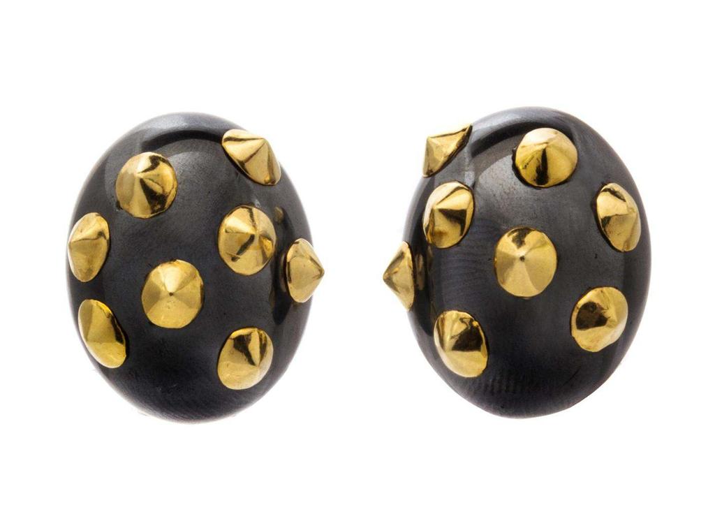 Angela Cummings Lot 294 A Pair of 18 Karat Yellow Gold and Hematite Earclips, Angela Cummings, consisting of two oval cabochon cut and polished