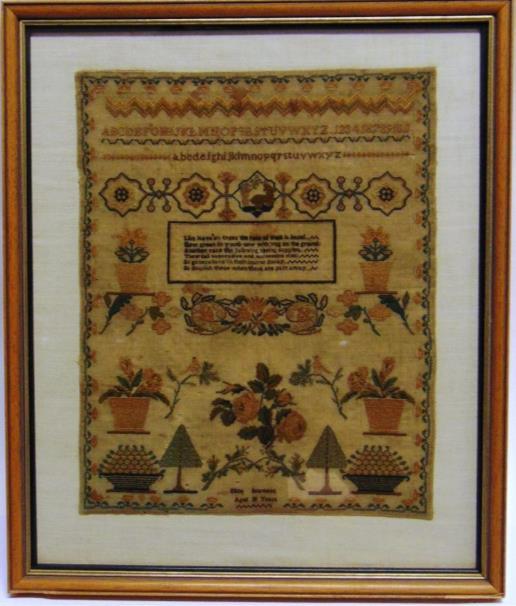 304 A NEEDLEWORK SAMPLER with verse, alphabet and floral designs, worked by Ellen Seamans, aged 10 years, 40cm x 33cm.