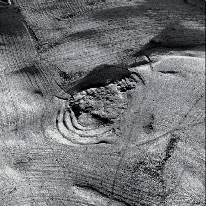 RCAHMS Fig 42. Fort and settlement Hownam Rings, Scottish Borders: this aerial photograph reveals the complex sequence of occupation on the site, which is set in a sea of rig and furrow cultivation.