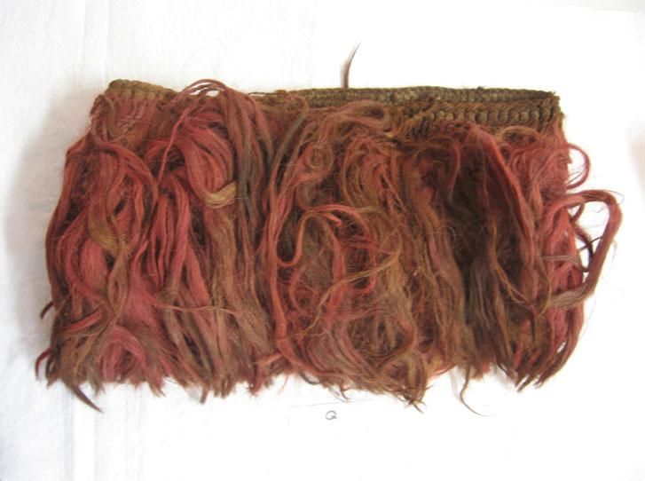 Object Q: Wari headdress 14 cm high x 40 cm interior circumference; hair from 7 to 23 cm long Camelid, hair This headdress or peluca (wig) has an interlaced tubular base of Z-spun camelid yarns.