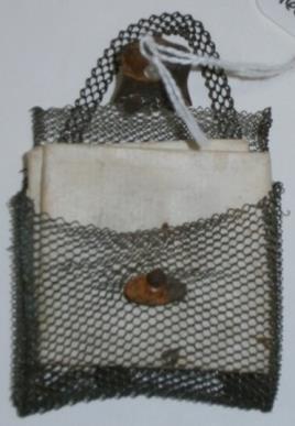 Very small wire mesh purse containing folded paper with locks of baby hair inside, 1845-1880 Transfer from Baker Library Special
