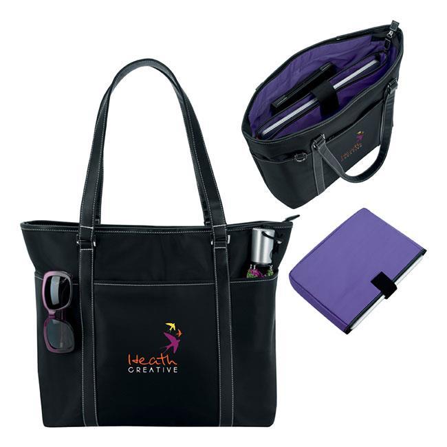 AP8008 She Rules Tote Large main compartment Full-length purple interior zippered pocket with organizer and removable laptop sleeve Features a tablet sleeve pocket Tapered shoulder-length handles and
