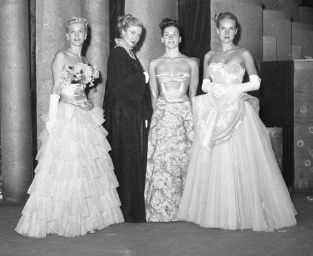 Evening gowns shown at a Los Angeles fashion show, 1947 An evening gown is a long flowing women's dress usually worn to a formal affair. It ranges from tea and ballerina to full-length.