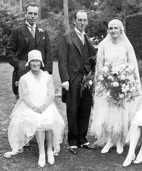 The woman to the far right is wearing a typical wedding dress from 1929. Up until the late 1930s, wedding dresses reflected the styles of the day.