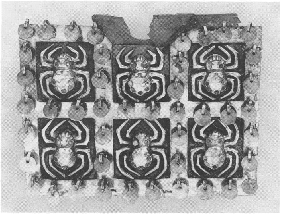 Figure 22. Nose ornament, Moche, from Loma Negra, Peru. Silver and gold, W. 8.6 cm. The spiders, the grid, and the dan- glers are gold sheet; the backplates are silver.